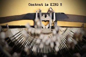 Designkalkulator bilde av skrivemaskin hvor det står Content Is King